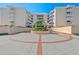 Circular driveway and entrance to the condo complex, enhanced with lush greenery at 6500 Sunset Way # 311, St Pete Beach, FL 33706