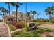 Community entrance featuring lush landscaping and community signage at 6500 Sunset Way # 311, St Pete Beach, FL 33706