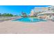 Inviting pool area features ample lounge chairs and meticulously kept surrounding patio at 6500 Sunset Way # 311, St Pete Beach, FL 33706