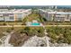 Beautiful community pool surrounded by lush landscaping and pristine sandy beach at 6500 Sunset Way # 311, St Pete Beach, FL 33706