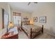 Bedroom with neutral tones features a desk, upholstered chair, and cozy bed at 6540 Tailfeather Way, Bradenton, FL 34203