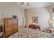 Bedroom featuring a desk and comfortable bed with coordinated nightstands and lamps at 6540 Tailfeather Way, Bradenton, FL 34203