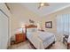 Cozy bedroom features a ceiling fan, wall art, and coordinating lamps on nightstands at 6540 Tailfeather Way, Bradenton, FL 34203