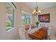 Chandelier-lit dining area with a window view at 6540 Tailfeather Way, Bradenton, FL 34203