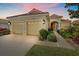 Charming home exterior featuring a well-manicured lawn, vibrant plants, and a two-car garage at 6540 Tailfeather Way, Bradenton, FL 34203