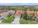 Beautiful exterior of the home with a red tile roof, lush landscaping, and an attached two-car garage at 6540 Tailfeather Way, Bradenton, FL 34203