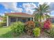 Well-maintained home exterior featuring a tile roof, screened lanai, and colorful landscaping at 6540 Tailfeather Way, Bradenton, FL 34203