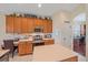 Bright kitchen with a stainless steel range, island and ample cabinet space at 6540 Tailfeather Way, Bradenton, FL 34203