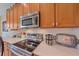 Close up on kitchen with a stainless steel range, counter top and cabinets at 6540 Tailfeather Way, Bradenton, FL 34203