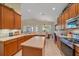 Well-lit kitchen open to the dining area, boasting an island and modern appliances at 6540 Tailfeather Way, Bradenton, FL 34203