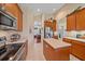 Spacious kitchen featuring stainless steel appliances, an island and tile floors at 6540 Tailfeather Way, Bradenton, FL 34203