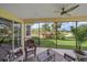 Relaxing screened lanai featuring comfortable seating and views of the beautiful green lawn and mature trees at 6540 Tailfeather Way, Bradenton, FL 34203