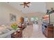 Open-concept living room with neutral tones, tile flooring, and a sliding door to the outdoor area at 6540 Tailfeather Way, Bradenton, FL 34203