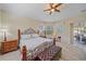 A spacious main bedroom with a sitting area, and a ceiling fan at 6540 Tailfeather Way, Bradenton, FL 34203