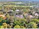 An aerial view showcasing the property surrounded by mature trees and lush landscaping in a gated community at 67 Sugar Mill Dr, Osprey, FL 34229