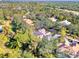 An aerial view showcasing the property's mature trees and verdant surroundings within the community at 67 Sugar Mill Dr, Osprey, FL 34229