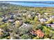 An aerial view shows a neighborhood with a lake and inter-coastal waterway in the distance at 67 Sugar Mill Dr, Osprey, FL 34229