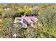 Overhead view of the home with screened lanai, nestled amidst lush trees and greenery at 67 Sugar Mill Dr, Osprey, FL 34229