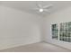 Carpeted bedroom featuring natural light and a ceiling fan at 67 Sugar Mill Dr, Osprey, FL 34229