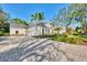 Beautiful, well-maintained home with a circular driveway and manicured landscaping at 67 Sugar Mill Dr, Osprey, FL 34229