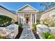 Attractive home has a columned portico entry, brick walkway and manicured landscaping at 67 Sugar Mill Dr, Osprey, FL 34229