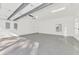 Spacious three-car garage with epoxy flooring, overhead lighting and bright white walls at 67 Sugar Mill Dr, Osprey, FL 34229