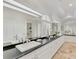 This bathroom has an elongated black granite countertop, travertine floors and a large window at 67 Sugar Mill Dr, Osprey, FL 34229