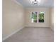 Clean, bright bedroom with neutral color palette and modern light fixture at 6705 20Th W Ave, Bradenton, FL 34209