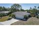 Well-maintained home featuring a two-car garage and mature tropical trees at 6705 20Th W Ave, Bradenton, FL 34209