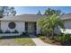 Charming home entrance with a decorative medallion, white trim, and tropical landscaping at 6705 20Th W Ave, Bradenton, FL 34209