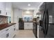 Modern kitchen with white cabinetry, wood countertops, and stainless steel appliances at 6705 20Th W Ave, Bradenton, FL 34209