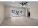 Spacious living room featuring tile flooring and sliding glass doors to the enclosed lanai at 6705 20Th W Ave, Bradenton, FL 34209