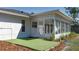 Exterior view of the bright sunroom, complimented by artificial turf at 6705 20Th W Ave, Bradenton, FL 34209