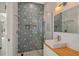 Modern bathroom featuring geometric tile shower, glass door, floating vanity and sleek fixtures at 746 Plymouth St, Sarasota, FL 34242