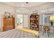 Comfortable bedroom featuring built-in bookcase and desk, with a sunlit sitting area beyond at 746 Plymouth St, Sarasota, FL 34242