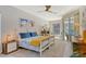 Bright bedroom features white wood frame bed, ceiling fan, and sliding glass doors to the pool area at 746 Plymouth St, Sarasota, FL 34242