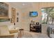 Well-lit bedroom features framed pictures on the wall, and a window showing palm trees at 746 Plymouth St, Sarasota, FL 34242