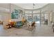 Bright living room with tile floors, contemporary furniture, and sliding doors to pool at 746 Plymouth St, Sarasota, FL 34242