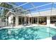 Relaxing screened-in pool area with lounge chairs, with easy access to the home through sliding glass doors at 746 Plymouth St, Sarasota, FL 34242