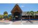 An inviting restaurant entrance features tropical decor, thatched roofing, and a covered walkway at 746 Plymouth St, Sarasota, FL 34242