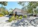 Beautiful home featuring a gravel driveway and meticulously landscaped yard with a two car garage at 746 Plymouth St, Sarasota, FL 34242