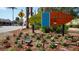 A colorful sign welcomes visitors to Siesta Key Village, surrounded by vibrant flowers and lush greenery at 746 Plymouth St, Sarasota, FL 34242