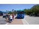 A blue Siesta Key Village trolley awaits passengers, offering convenient transportation around the area at 746 Plymouth St, Sarasota, FL 34242