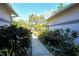 A walkway between two houses lush with plants and flowers at 746 Plymouth St, Sarasota, FL 34242