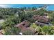 Aerial view showcasing the property's roof, lush landscaping, and community layout near the water at 7921 4Th W Ave, Bradenton, FL 34209