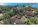 Aerial view showcasing the property's roof, lush landscaping, and community layout near the water at 7921 4Th W Ave, Bradenton, FL 34209