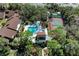 Aerial view of backyard with in-ground pool, tennis court, and lush landscaping at 7921 4Th W Ave, Bradenton, FL 34209