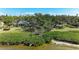 Aerial view of waterfront property with mature trees, lush lawn, and private beach access at 7921 4Th W Ave, Bradenton, FL 34209