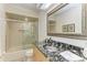 Modern bathroom featuring a black stone sink, large mirror, and walk-in shower at 7921 4Th W Ave, Bradenton, FL 34209