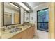 Bathroom featuring dual vanities, granite countertops, and decorative framed mirrors at 7921 4Th W Ave, Bradenton, FL 34209